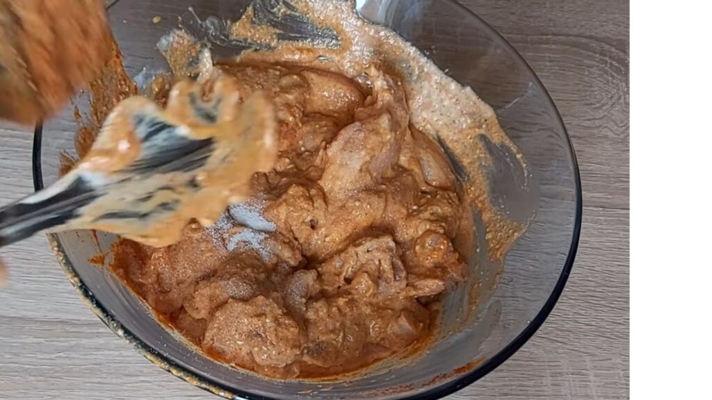 Gluten-Free Chicken Biryani | A Simple Twist on a Classic 5 "A bowl of chicken pieces coated in Greek yogurt, ginger-garlic paste, turmeric, chili, and garam masala, ready to marinate for a flavorful kick."