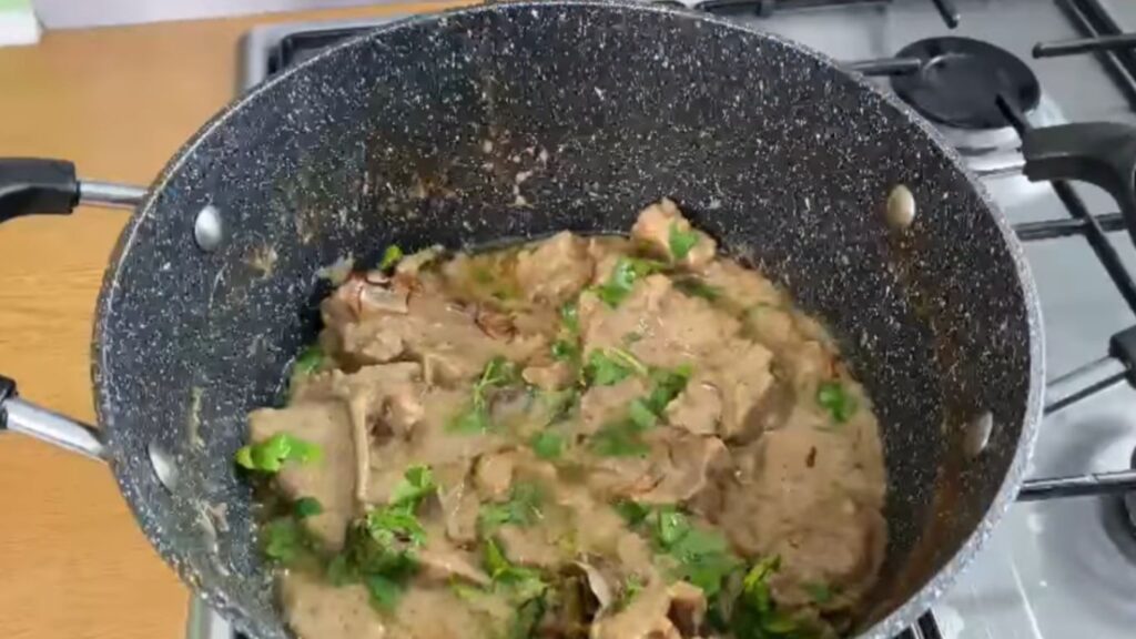 Mutton pieces in a bowl, coated with Greek yogurt, ginger-garlic paste, turmeric, chili, and garam masala, ready to marinate for a tender, rich taste."