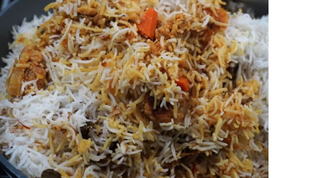 Colorful Gluten-Free Vegetable Biryani | Light and Healthy 9 A close-up of finished gluten-free vegetable biryani, fluffed with a fork, showcasing fluffy rice and colorful veggies garnished with coriander & mint, served hot and ready to enjoy. Colorful Gluten-Free Vegetable Biryani | Light and healthy